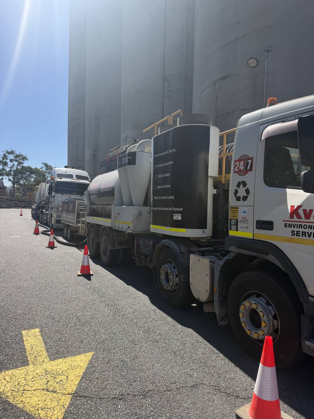 Line of KVAC vacuum excavation trucks staged at an industrial site
