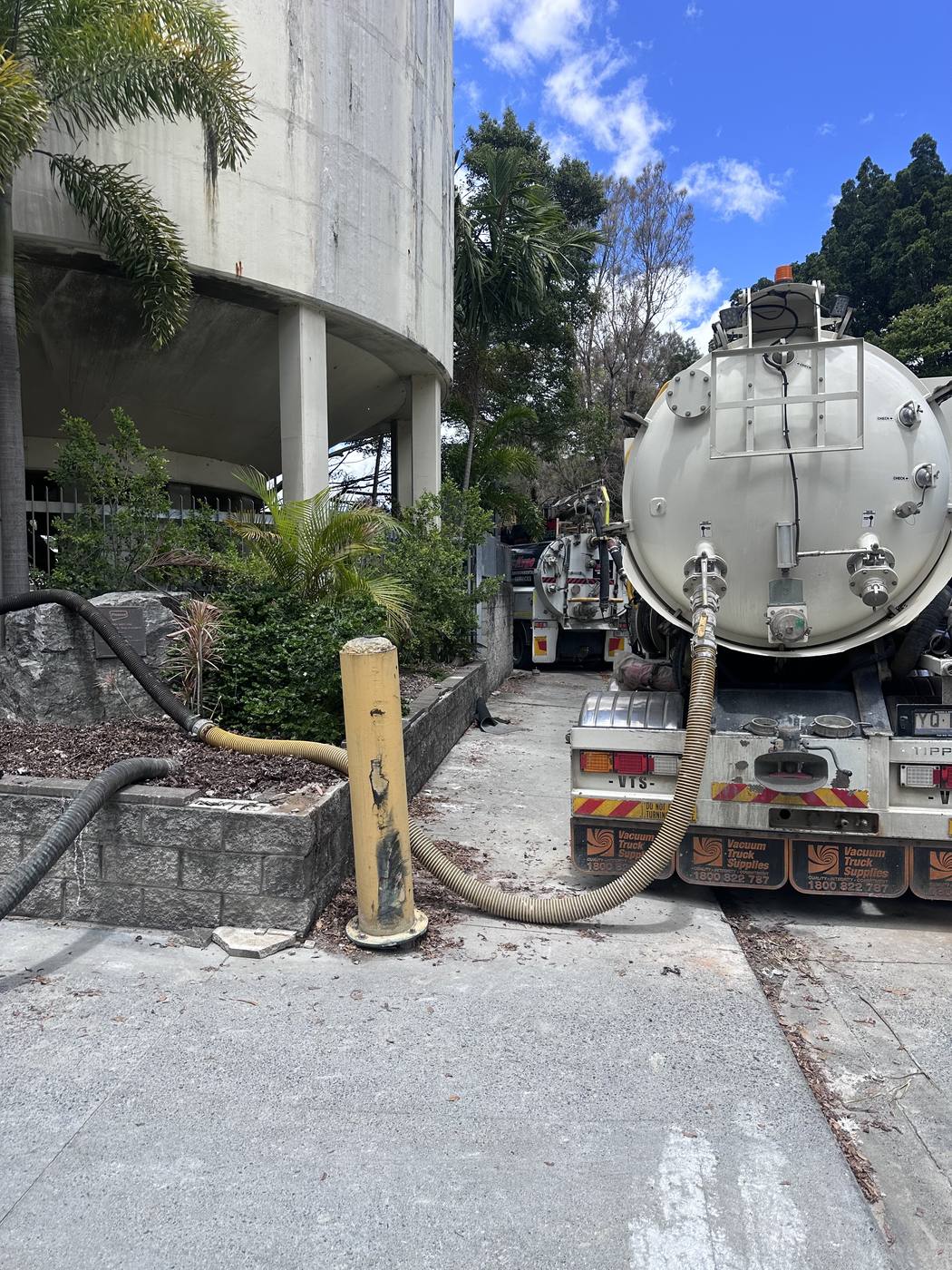 KVAC vacuum trucks staged at the base of a water reservoir during a large tank job